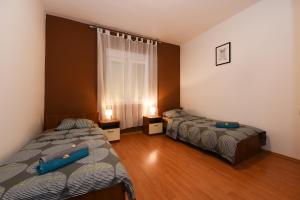 a bedroom with two beds and a window at Apartman Croatia Zadar in Zadar