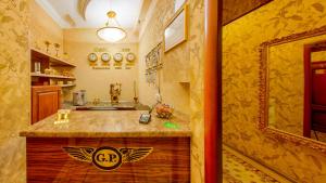 a bathroom with a sink and a counter with a mirror at Hotel Golden Palace in Saint Petersburg