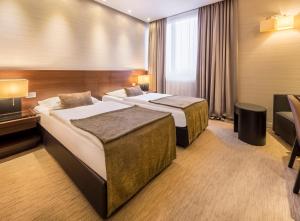 Postel nebo postele na pokoji v ubytování Hotel Residence