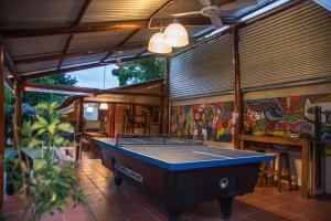 a pool table in the middle of a patio at Feliza Hostel in Villa Carlos Paz