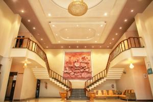 a lobby with stairs and a painting on the ceiling at Hotel Pushkar Legacy in Pushkar
