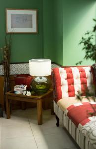 a living room with a couch and a table with a lamp at Hotel Alcides in Ponta Delgada