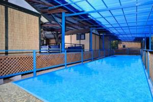 a large pool of blue water in a building at Adam's Farm in Eli Ad