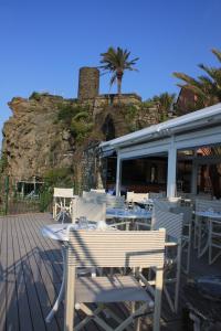 a restaurant with white tables and chairs on a deck at Hotel Gianni Franzi in Vernazza