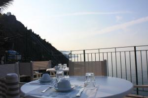 a table on a balcony with a view of the ocean at Hotel Gianni Franzi in Vernazza