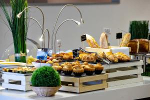 a buffet of bread and pastries and other food items at Mercure Paris Vaugirard Porte De Versailles in Paris