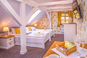 a bedroom with two beds and a table at Chata Pogaduchy in Ronin +80 photos