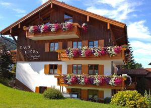 a building with flower boxes on the side of it at Haus Petra in Oberjoch