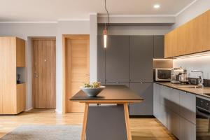 a kitchen with a table and a bowl on it at Maironis 2 - Grand Apartment in the Heart of Kaunas in Kaunas