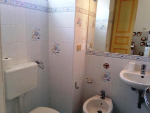 a bathroom with a toilet and a sink at La casa sul mare in Lipari +11 photos