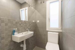 bagno con lavandino, servizi igienici e finestra di The Rentals Collection | Verona a San Sebastián