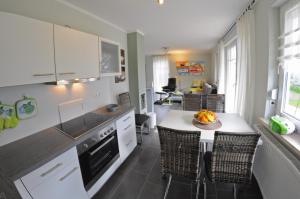 a kitchen with a table with a bowl of fruit on it at Ferienhaus Müritzidyll / EG-Appartement in Marienfelde