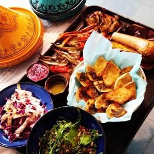 a tray filled with different types of food on a table at Adam's Farm in Eli Ad