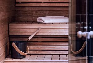 a sauna with a towel and a bucket at Arctic Light Hotel in Rovaniemi