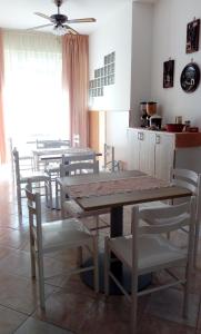 a dining room with a wooden table and chairs at B&B Nonna Maria in Lizzano