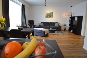 a living room with a table with fruit on it at Apartment Pfungstadt in Pfungstadt