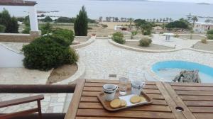 a table with a tray of bread and drinks on it at Rose's House in Grótta