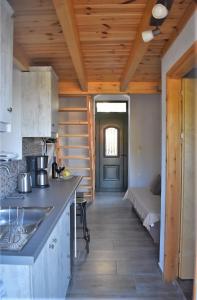 a kitchen with a counter and a bed in a room at Christos Raches traditional houses in Raches