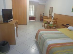 a hotel room with a bed and a flat screen tv at Magnus Plaza Hotel in Macapá