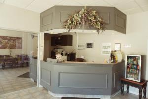 a kitchen with a counter with flowers on it at Motel Casino in Gatineau