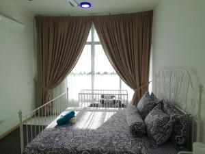 a bedroom with a bed and a large window at Guesthouse at Shah Alam in Shah Alam