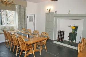 a dining room with a wooden table and chairs at Seatoller House in Borrowdale