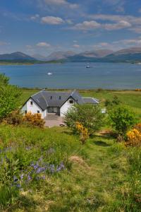 a house on a hill with a view of the water at Seabank House in Oban