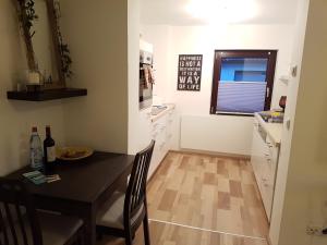 a kitchen with a table and a dining room at Ferienwohnung Karola in Bad Bocklet