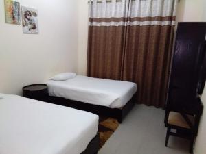 Postel nebo postele na pokoji v ubytování Al Smou Hotel Apartments - MAHA HOSPITALITY GROUP