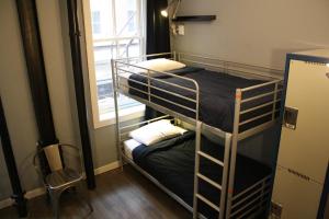 two bunk beds in a room with a window at Apple Hostels of Philadelphia in Philadelphia