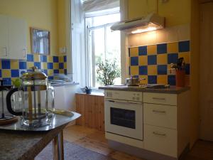 a kitchen with a stove and a window at Kinneil Self Catering in Lamlash