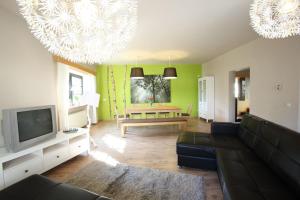 a living room with a couch and a tv at Gasthof Berghof in Presseck