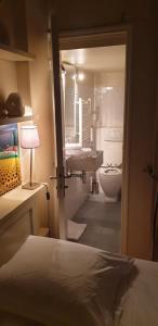 a bathroom with a bed and a sink and a toilet at Transparent Marais in Paris