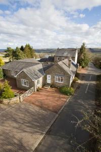 an aerial view of a house with a driveway at Stable Cottage in Bardon Mill