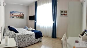 a bedroom with a bed and a large window at B&B Valverde in Verona