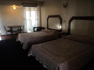 Ένα ή περισσότερα κρεβάτια σε δωμάτιο στο Hotel San Luis de Nogales