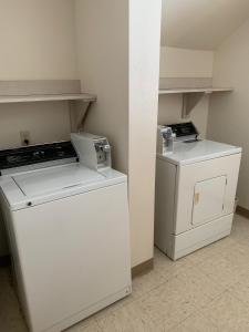 a kitchen with two washers and a dishwasher at AmericInn by Wyndham Hampton in Hampton