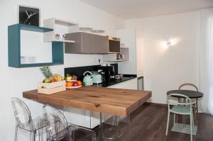 a kitchen with a wooden table and chairs at HOMY BnB in Empoli