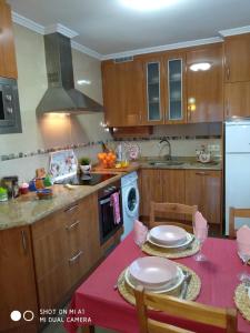 a kitchen with a table with two plates on it at Calle Maliayo in Villaviciosa