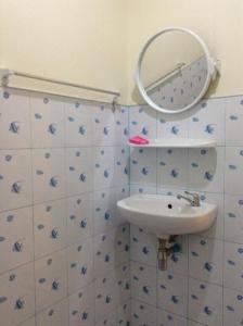 a bathroom with a sink and a mirror on the wall at Wattana Bungalow in Nai Yang Beach