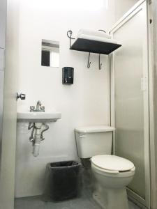 a bathroom with a toilet and a sink at Casa Zapopan Hotel in Guadalajara