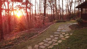a stone path in a garden with the sun setting at Barefoot Hills in Dahlonega