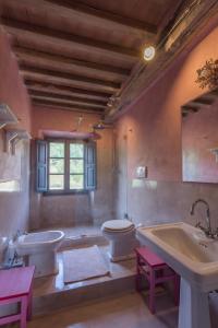 a bathroom with a tub and a toilet and a sink at Podere San Niccola in Punta Ala