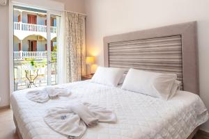 a bedroom with a large bed with towels on it at Anamar Zante Hotel in Argasi