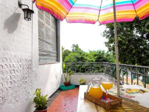 a table with an umbrella and two glasses of orange juice at Hostel Recanto de Alegrias em São Cristòvão in Rio de Janeiro