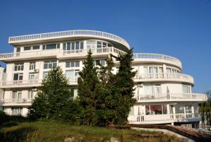 a white building with trees in front of it at Family Hotel Casablanca Green in Varna City