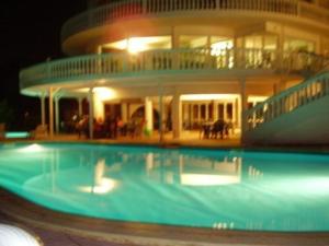 a large house with a swimming pool at night at Family Hotel Casablanca Green in Varna City