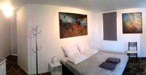 a bedroom with a bed and two paintings on the wall at Casa ilicia in Eus