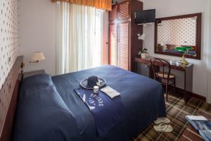 Postel nebo postele na pokoji v ubytování Hotel Astro
