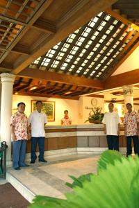 a group of men standing in a hotel lobby at Almont Inland Resort in Butuan
